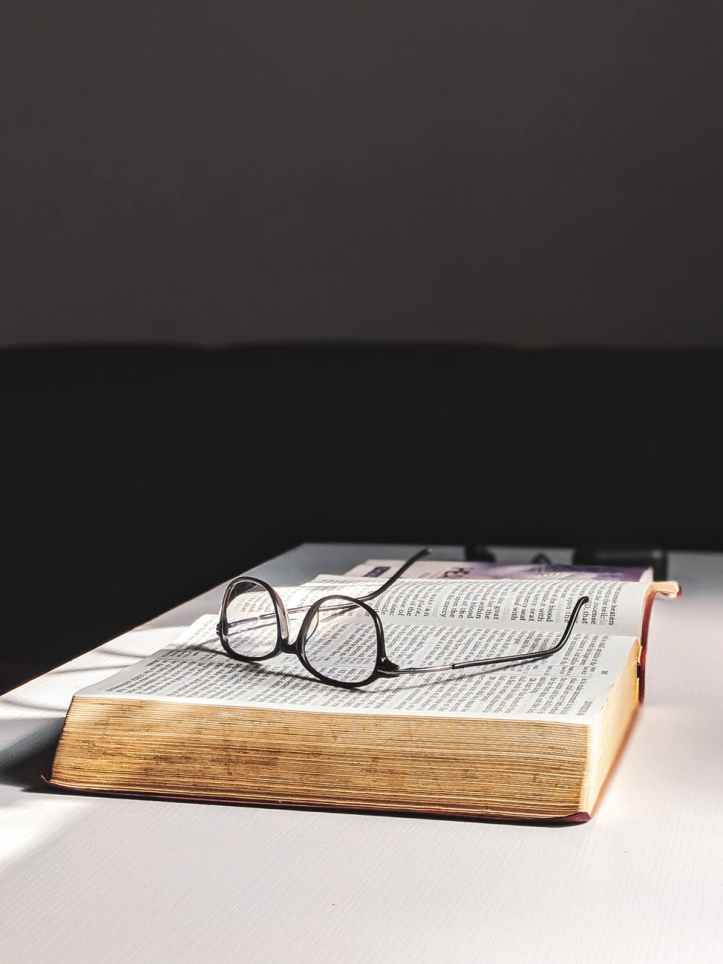 photo of eyeglasses on top of the book
